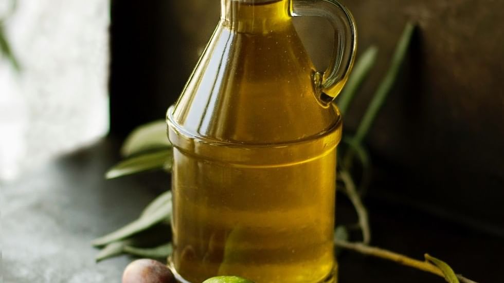 Close-up of olive oil bottle & olives at Falkensteiner Hotels