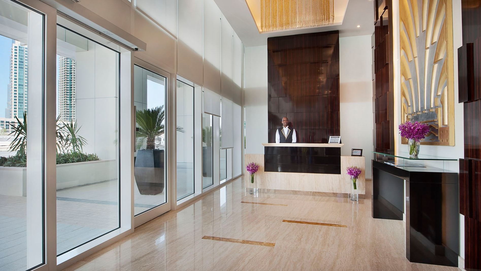 Entrance of reception area with concierge desk at DAMAC Maison Canal Views