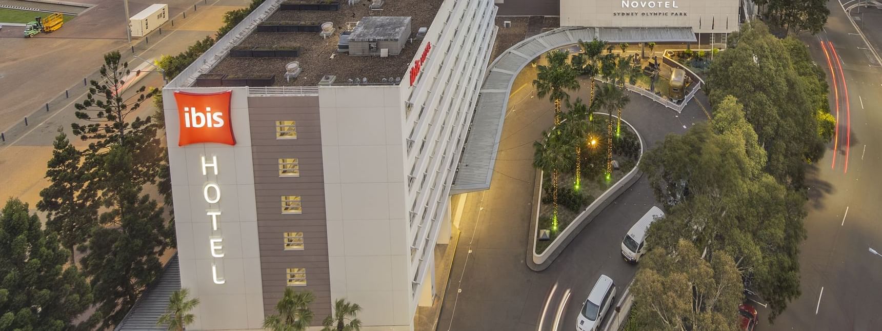 Aerial view of Novotel Sydney Olympic Park with The Driveway and surrounding greenery