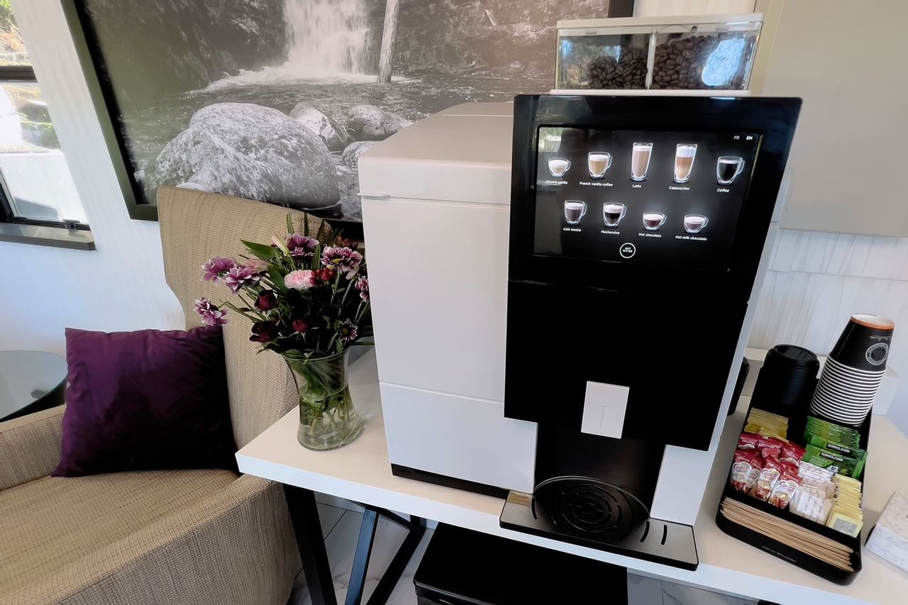 Coffee machine with coffee cups, teabags and sugar packets