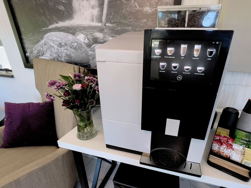 Coffee machine with coffee cups, teabags and sugar packets