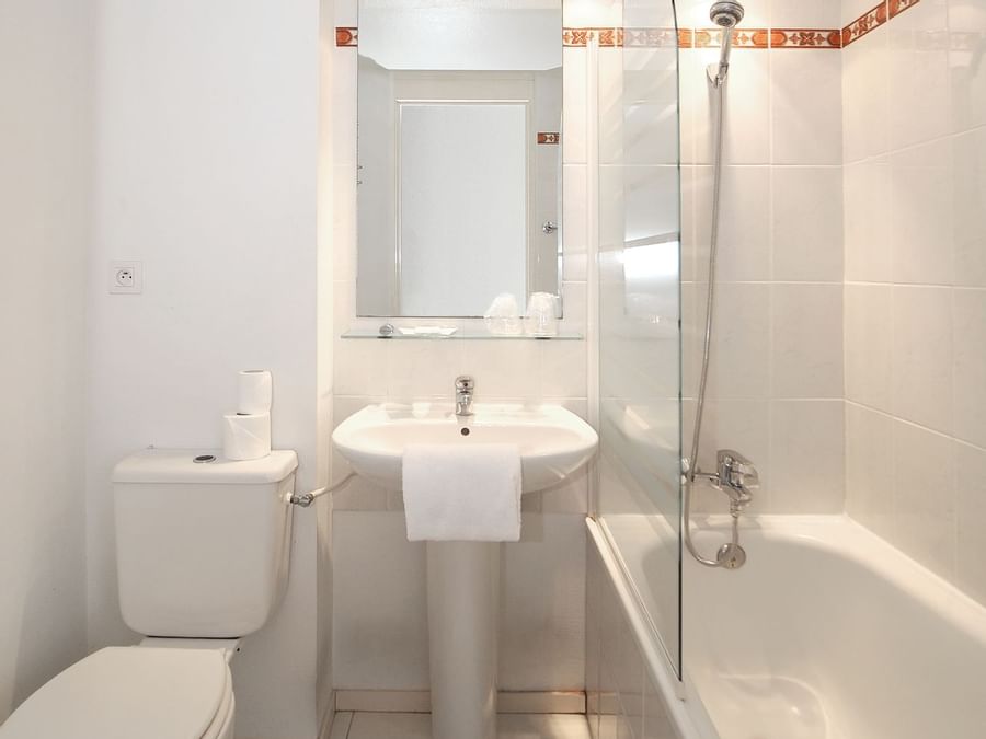 Bathroom with pedestal sink  & bathtub at Hotel Ambacia
