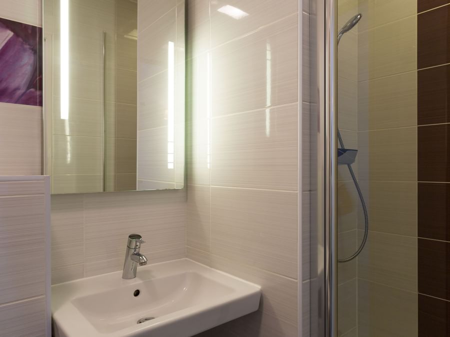 A bathroom in a room at Hotel Les Poemes de Chartres