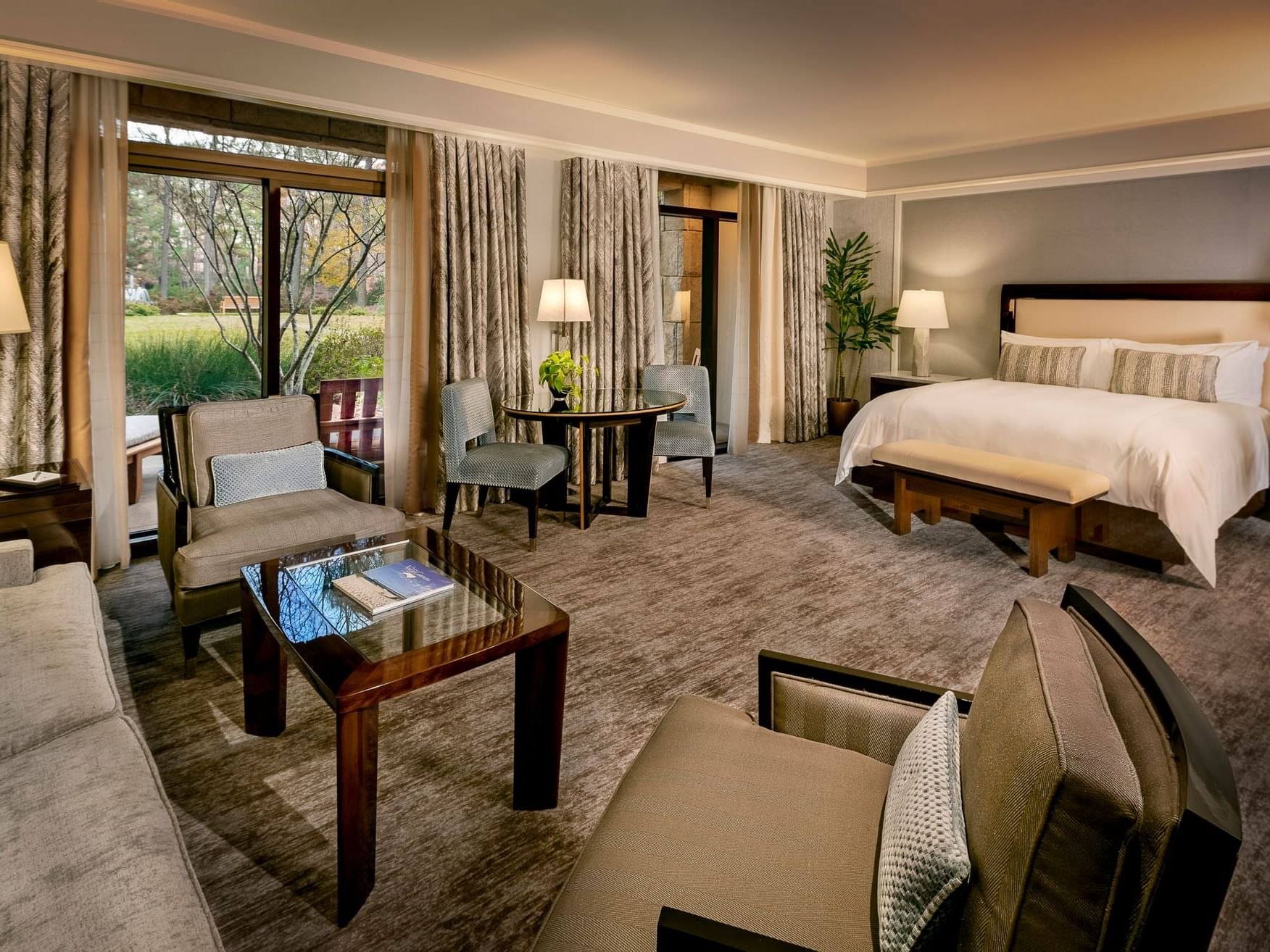 Interior of Spa Level Suite with a Patio lounge overlooking the woodland setting at The Umstead Hotel and Spa