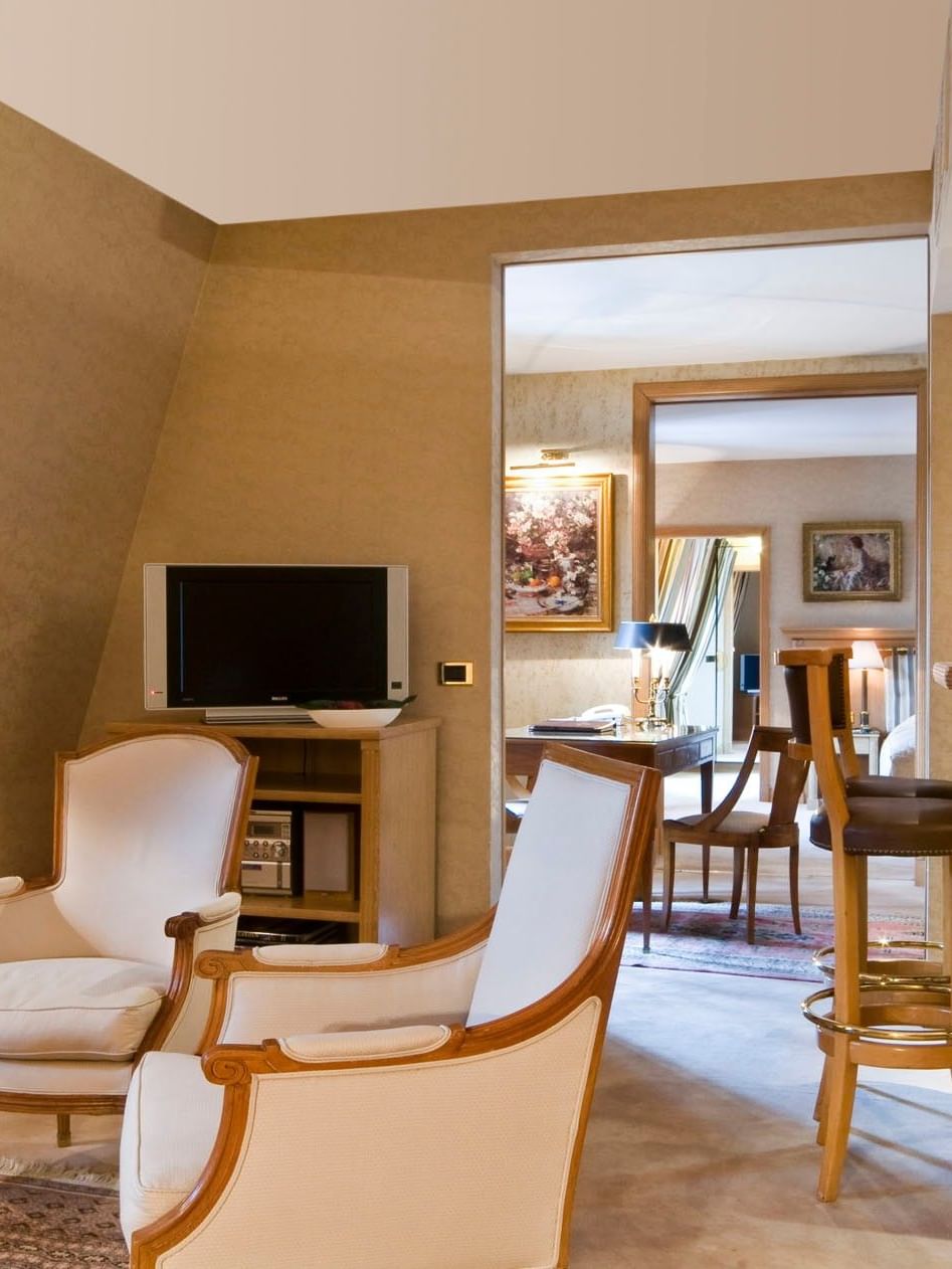 TV lounge with plush couches and a work desk in Royal Suite at Warwick Grand Place Brussels