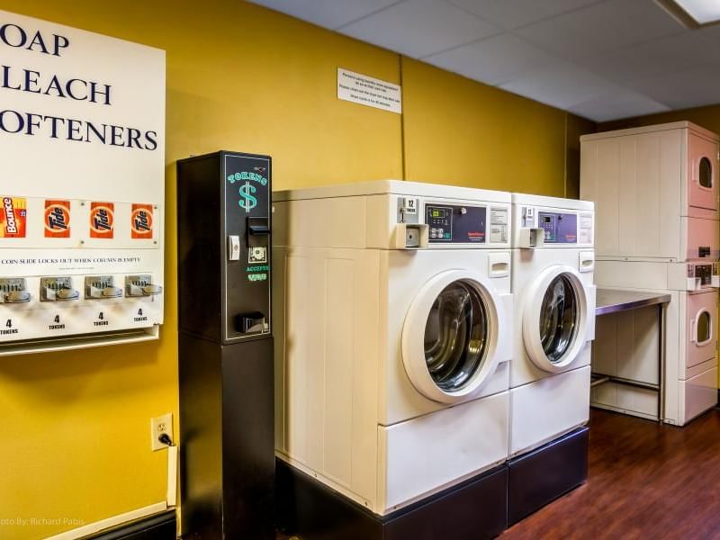 Laundry room featuring a washer, dryer and soap dispenser at Rosen Inn Hotels and Resorts