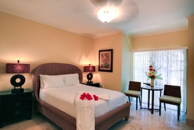 Comfortable double bed with table lamps in Studio room at Windsong Resort On The Reef