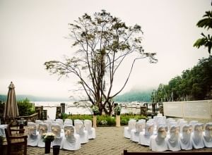 wedding chairs overlooking water on a cloudy day