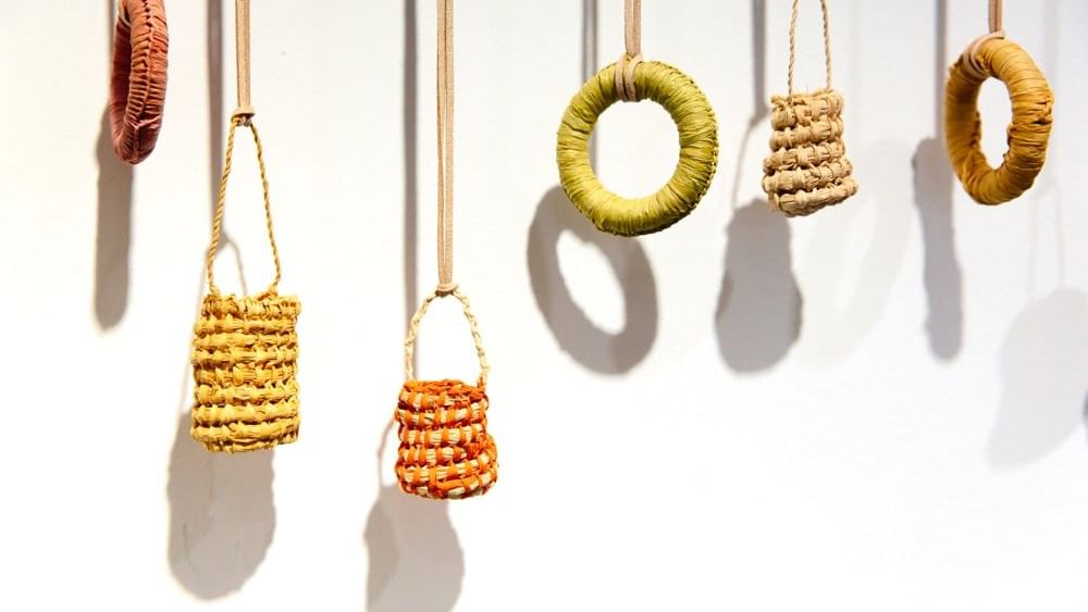 Woven baskets and rings hanging from strings at Kew-Y-Ahn Aboriginal Gallery.