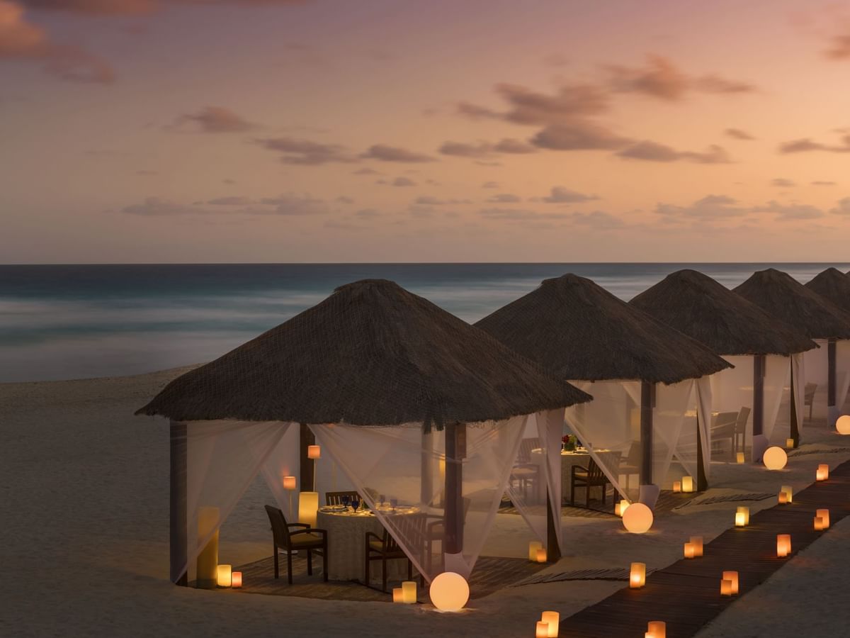 Cabanas with thatched huts and dining tables at Casitas in Kempinski Hotel Cancún