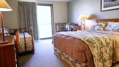 The Pineys interior featuring a large bed and a smaller twin bed, with a window at The Ranch at UCross