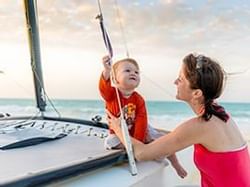 Women holding a baby on a boat enjoying a sailboat ride near Bayside Inn Key Largo