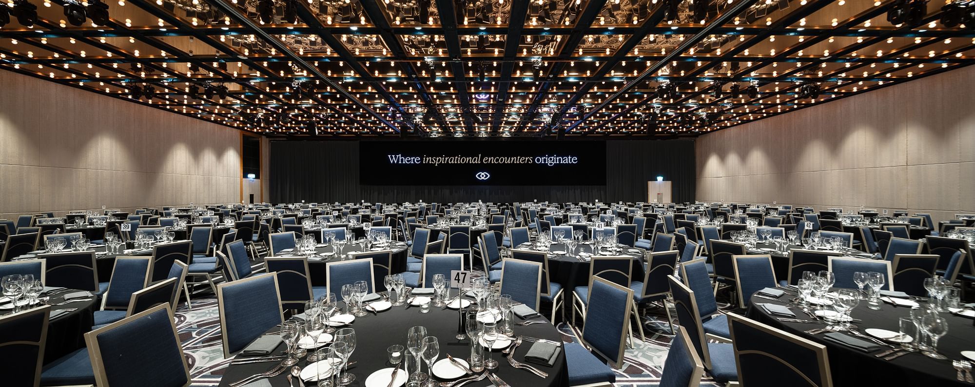 Banquet hall with numerous tables and chairs.