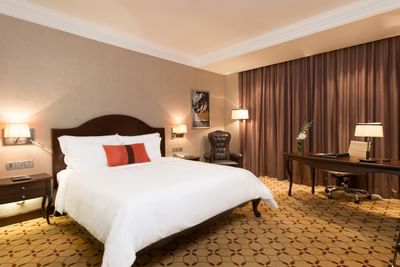 Deluxe Room with a king size bed & a working desk at Eastin Grand Hotel Saigon