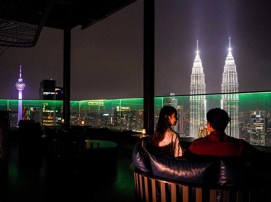 Couple rooftop bar view KL Tower and Petronas Twin Towers Imperial Lexis KL