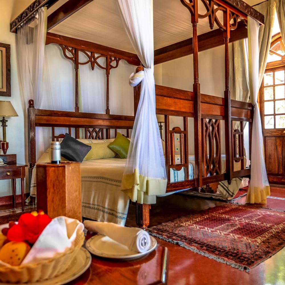 Elegantly decorated Honeymoon Prime Room at Zanzibar Serena Hotel in Zanzibar with a canopy bed.