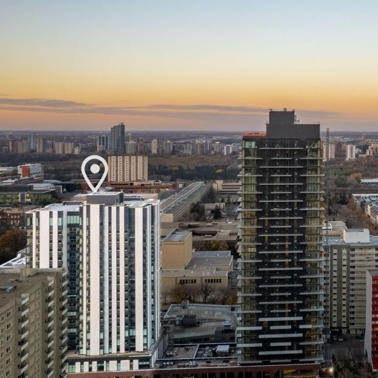 A white-coloured tower with a location marker contrasts with the city of Edmonton in the background.