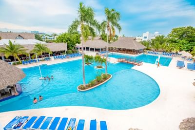 Slides by the outdoor pool area on a sunny day at Playa Blanca Beach Resort