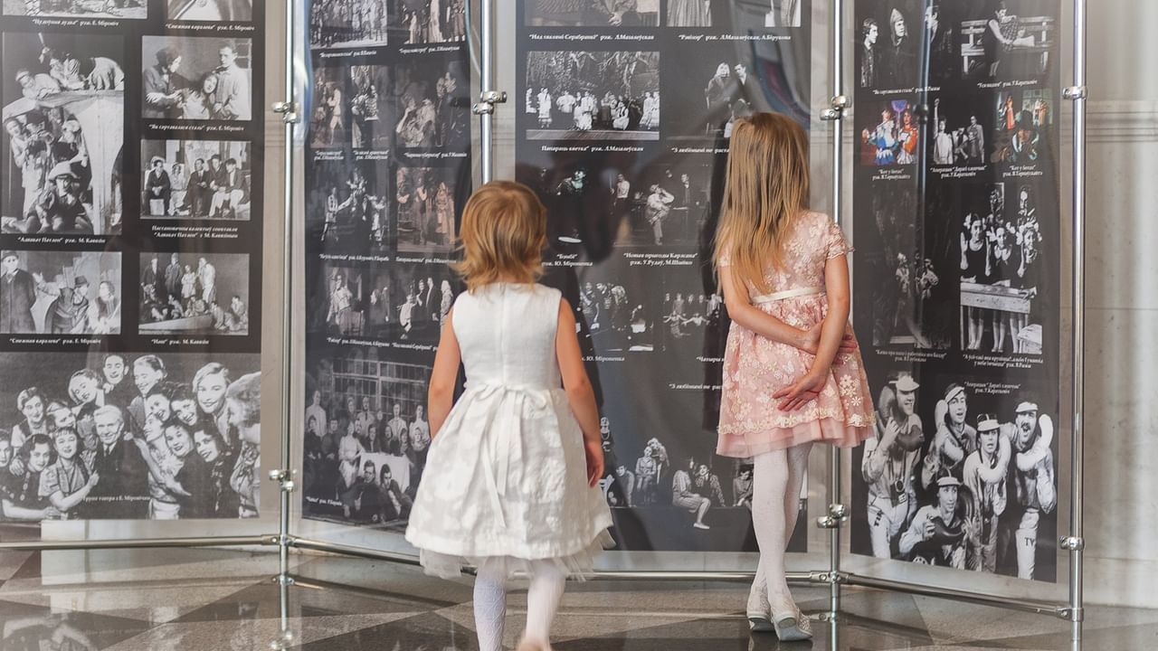 Two kids looking at a photo exhibition