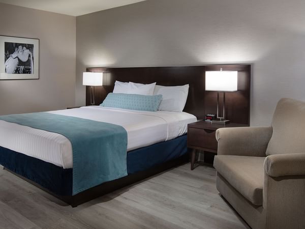 Bed and sofa chair in hotel room