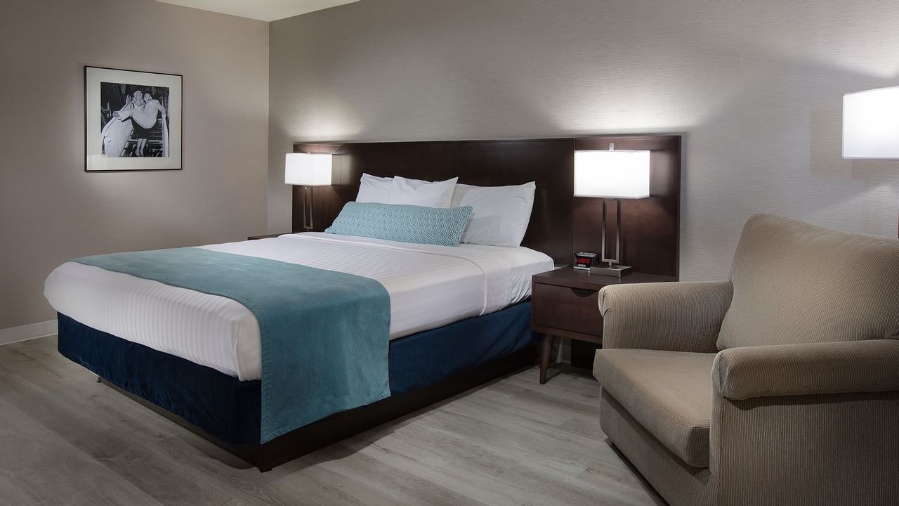 Bed and sofa chair in hotel room