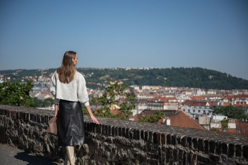 Lady overlooking the city from a view point near Almanac X Alcron Prague, 5 star hotels in Prague