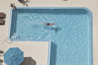 Ariel view of a person swimming in the outdoor pool at Waikiki Resort Hotel by Sono
