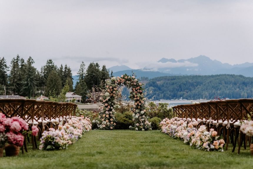 Wedding arrangements with floral décor in Waterfront Lawn at Alderbrook Resort & Spa