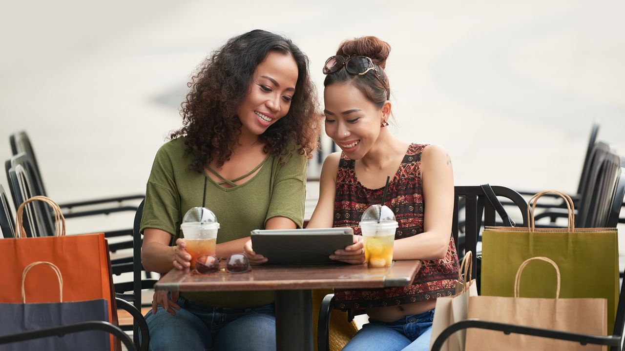 friends in a cafe with shopping bags