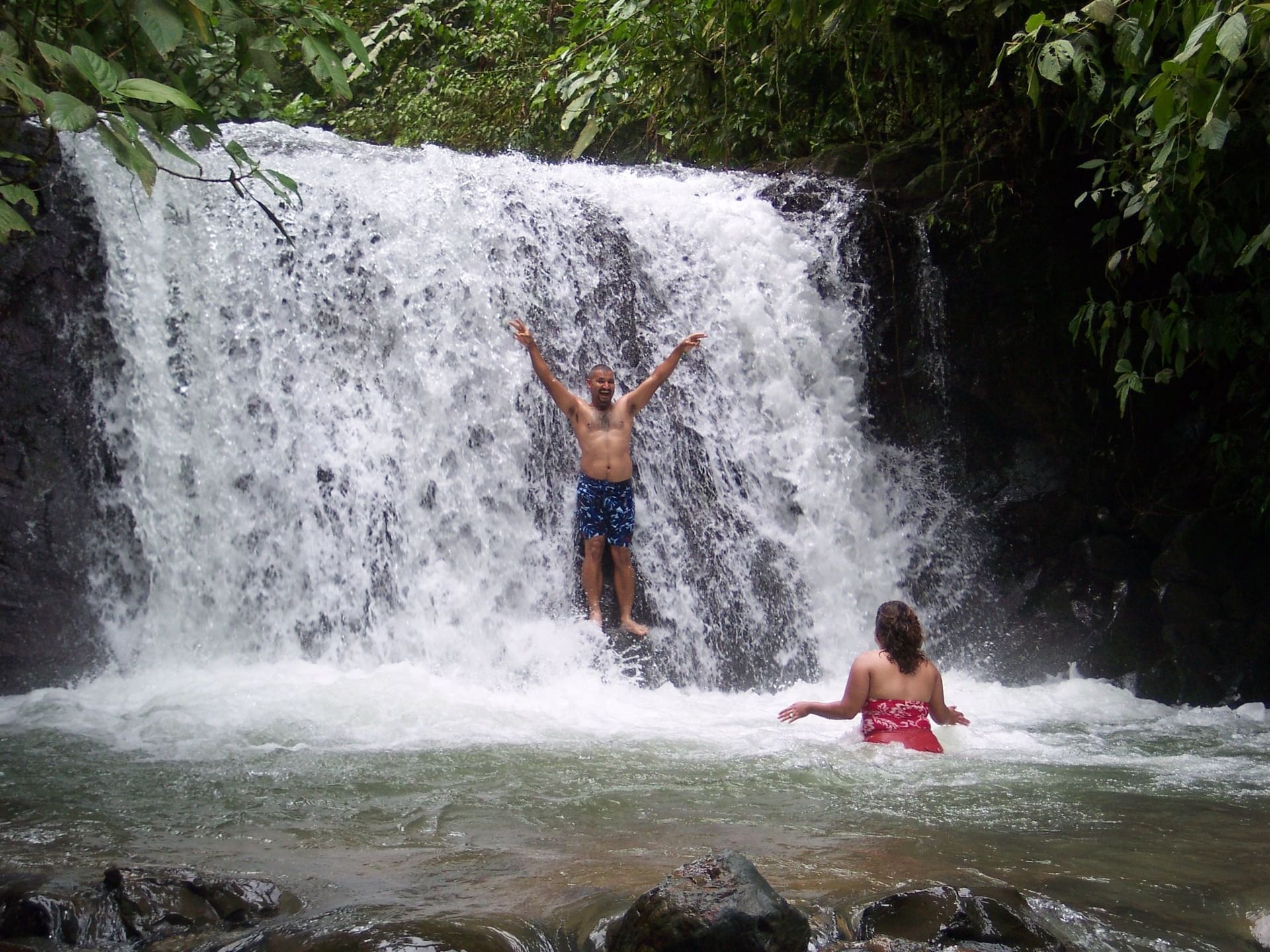 Couple enjoying Nauyaca Waterfalls with lush greenery near Los Altos Resort