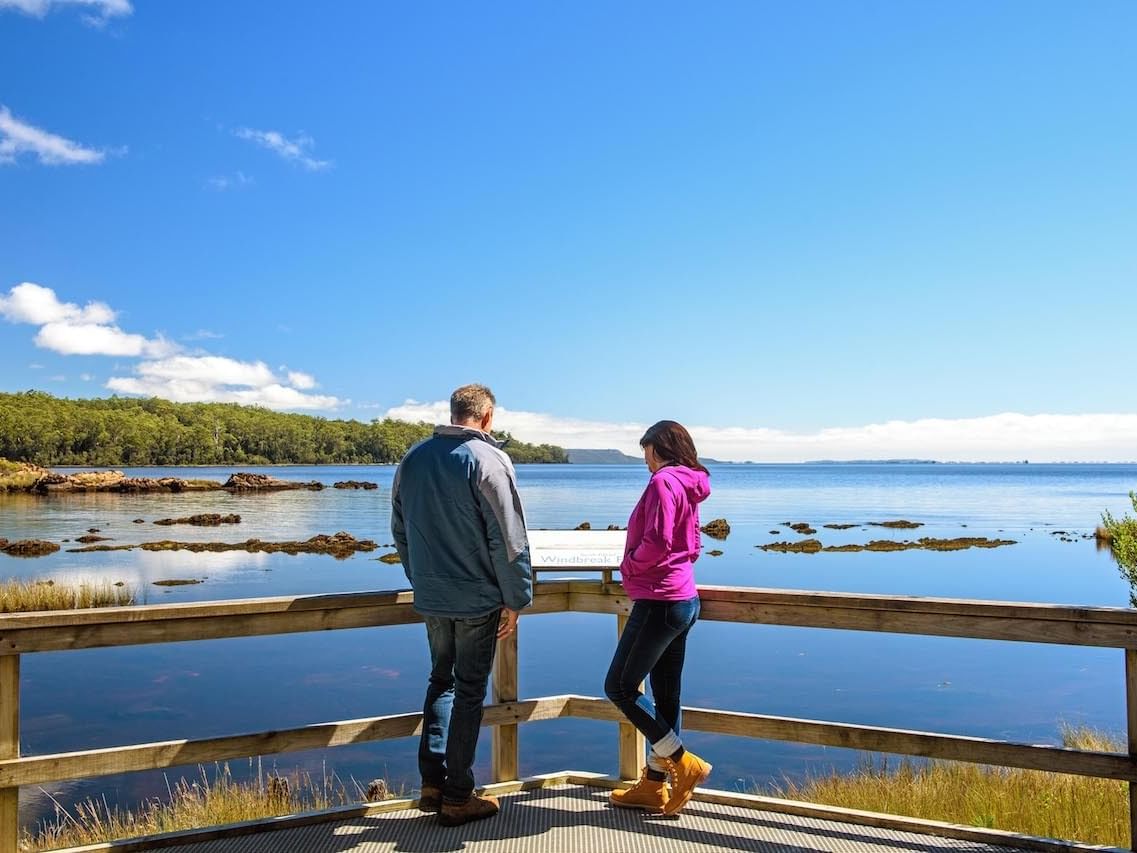 Couple on the jetty in Macquarie Harbor near Strahan Village