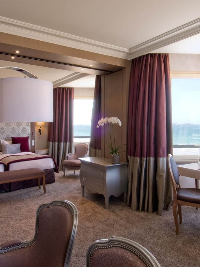 Interior of a Suite featuring carpeted floors & twin beds with Sea view at Le Grand Hôtel des Thermes