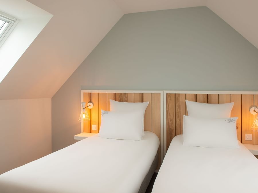 Twin beds in Hotel Sports & Spa at The Originals Hotels