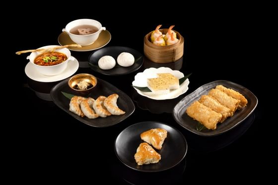 Plates of Steamed Phoenix Prawn with Chicken, Baked Barbecued Pork Pastry, Chilled Osmanthus Coconut Jelly, and Soups at Goodwood Hotel
