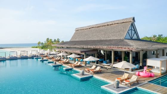 Breeze Poolside Dining & Bar with thatched roofs at Grand Park Kodhipparu, Maldives