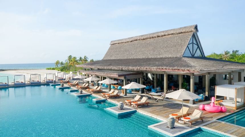 Breeze Poolside Dining & Bar with thatched roofs at Grand Park Kodhipparu, Maldives