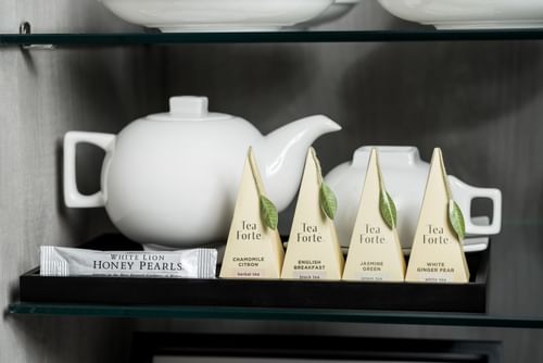 White teapot & tea amenities in rooms at Innovation Hotel