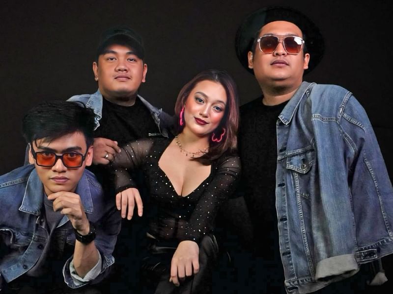 Four-member band posing against a sleek black backdrop at Sunway Resort
