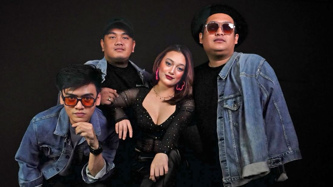 Four-member band posing against a sleek black backdrop at Sunway Resort