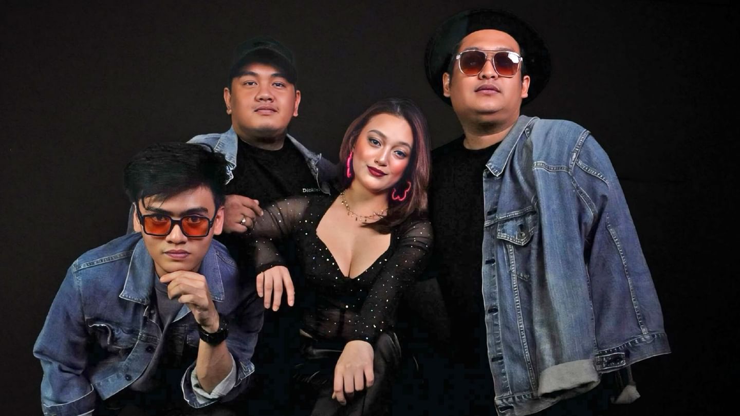 Four-member band posing against a sleek black backdrop at Sunway Resort