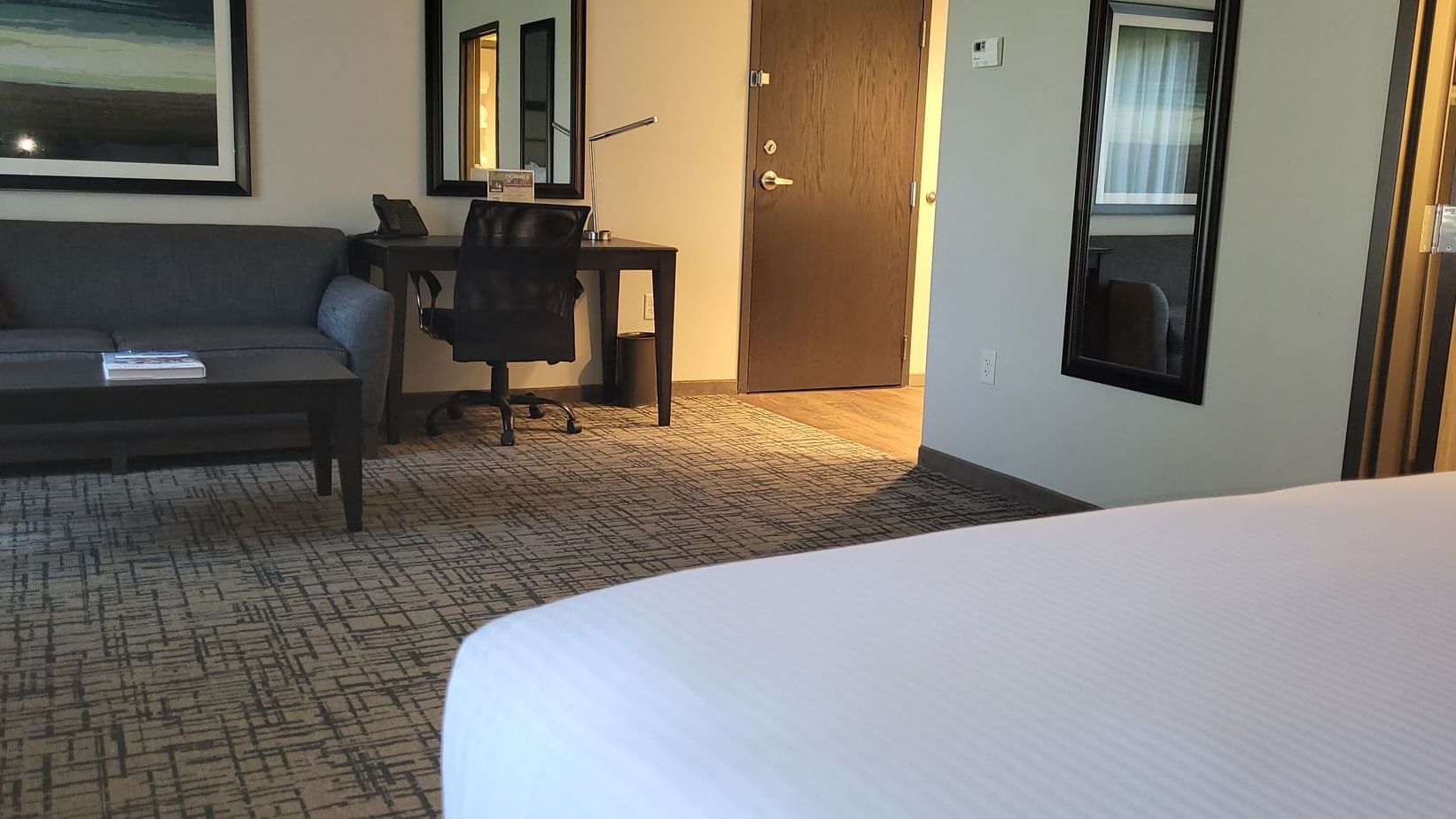 Work desk with a chair by the sofa in King studio room at Shangri-La Monkey Island