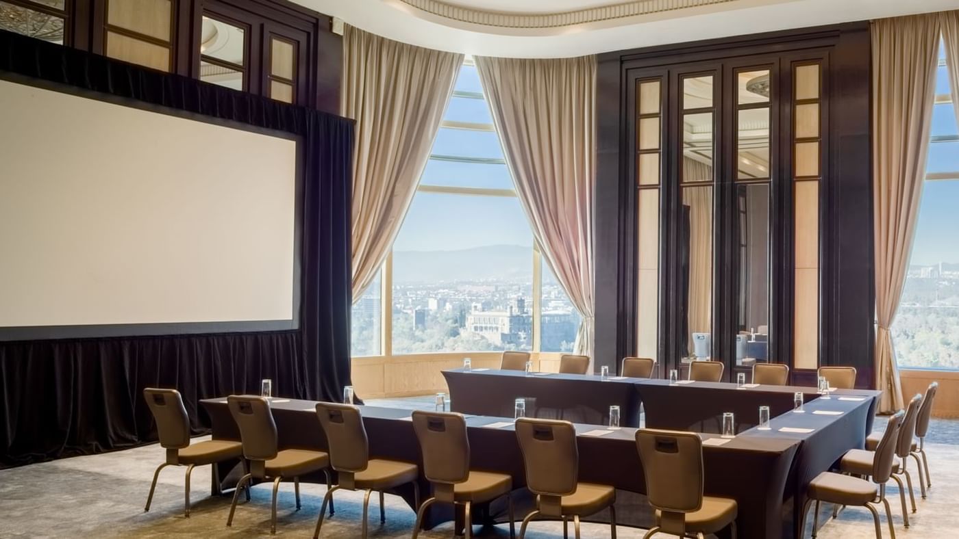 U-shaped meeting table with screen at Grand Fiesta Americana