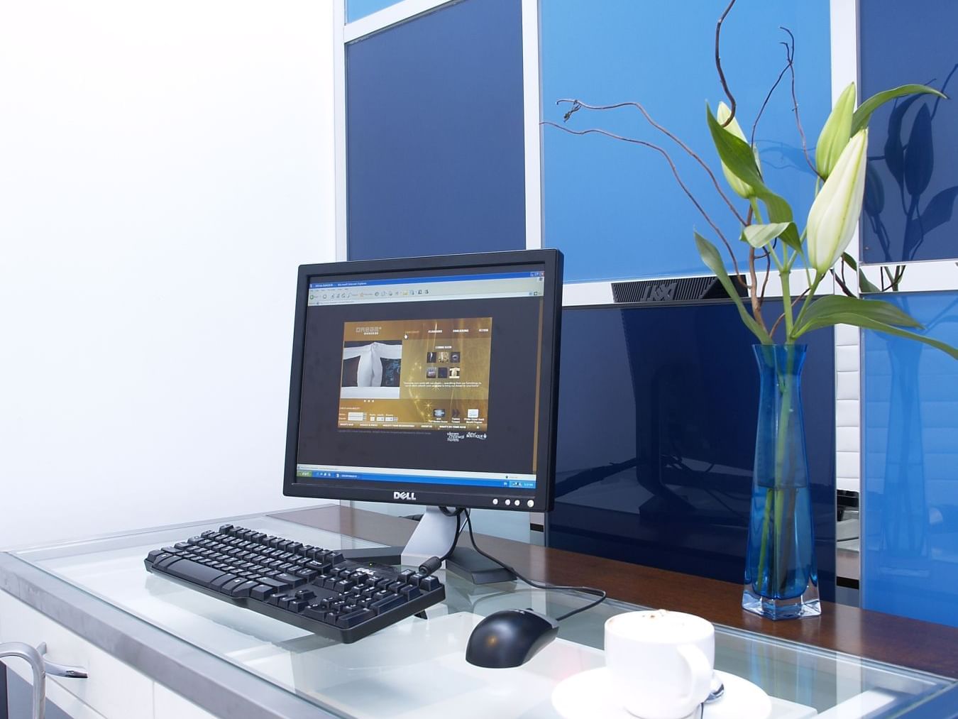 Desktop computer set up on glass table at Dream Hotel