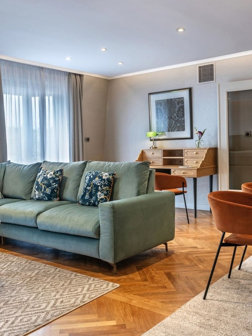 Work desk and dining table by the living area of the Executive Suite with wooden floors at Warwick Reine Astrid - Lyon