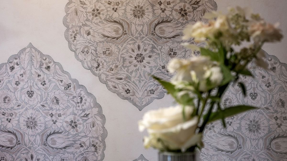 White flowers in vase against patterned wallpaper in Junior Suite at Warwick New York