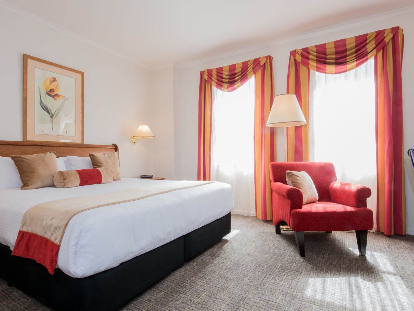 Bed & chair in King Spa Room at Hotel Grand Chancellor