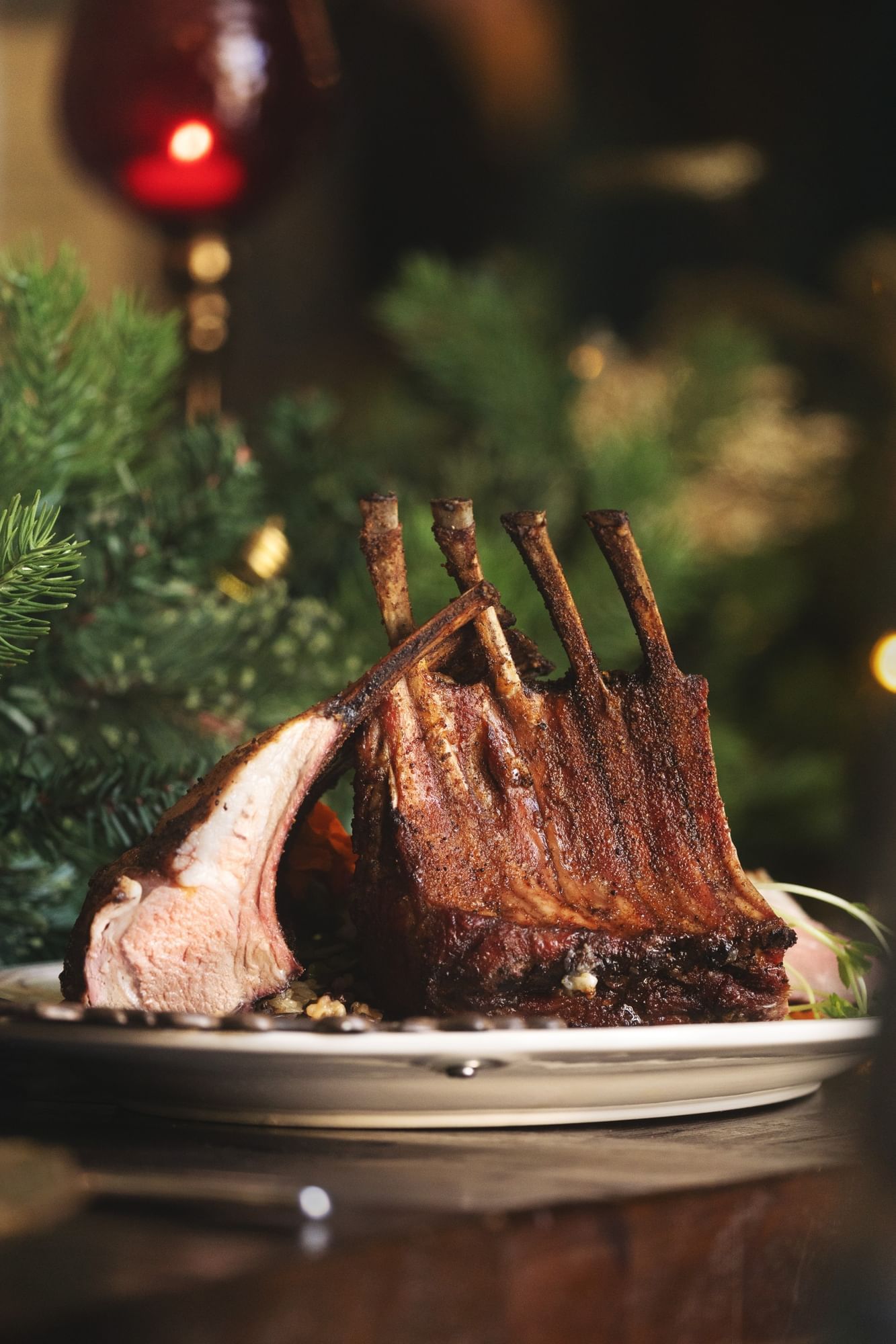 Lorem ipsum Plated rack of lamb on a wood dining table