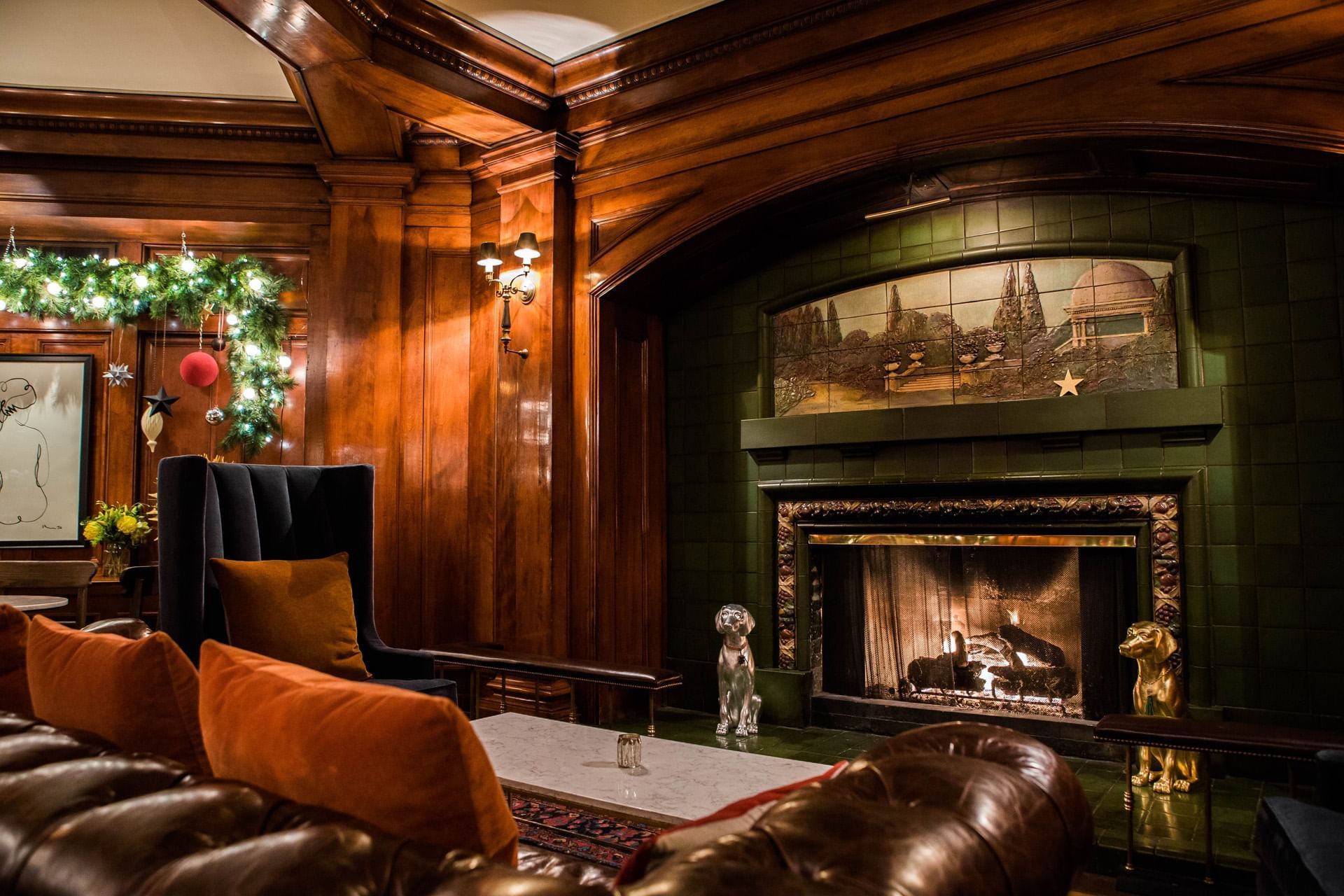 Fireside Room with a piano, plush seating, and fireplace at Hotel Sorrento