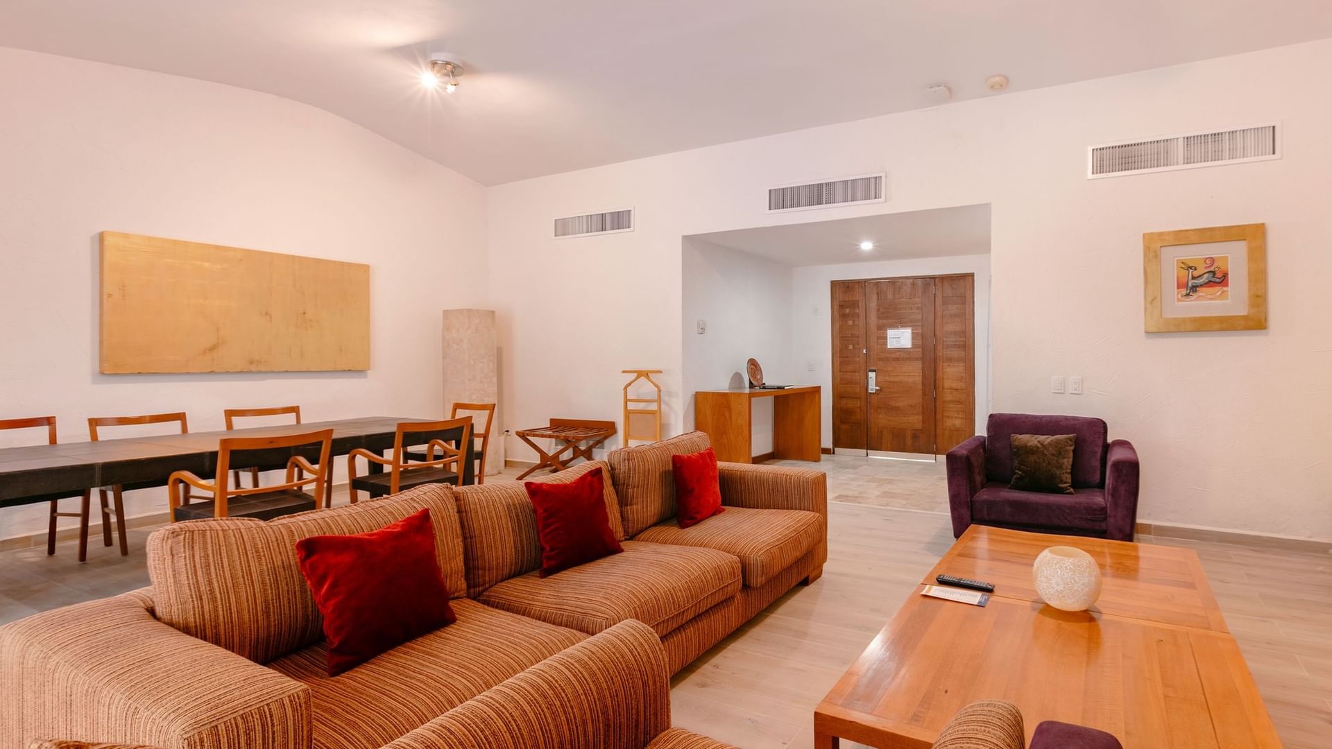 Spacious living area with a couch, coffee table, and dining set at Camino Real Guadalajara in Zapopan