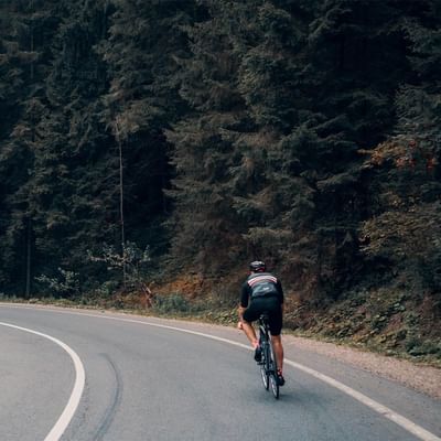 A boy cycling on a road near Falkensteiner Hotels